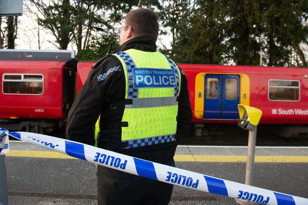 Police guard the South Western Trains service at Horsley station following Friday's incident.