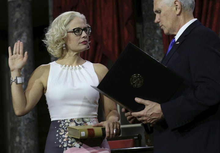 Sen. Kyrsten Sinema (D-Ariz.) participates in a ceremonial swearing-in on January 3, 2019. Rather than use a traditional Bible, she placed her hand on a book from the Library of Congress that contains the texts of the Arizona and U.S. constitutions, a spokesperson said.