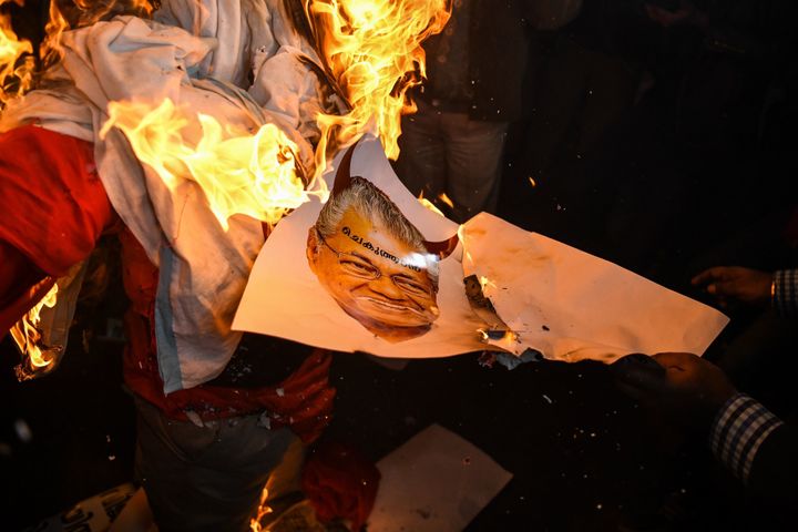 Right wing activists burn effigy of Chief Minister of Kerala Pinarayi Vijayan during a demonstration over two women entering the Sabarimala Ayyapa temple in the southern state of Kerala
