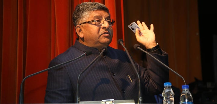 Union IT Minister Ravi Shankar Prasad flashing his Aadhaar at the Indian Science Congress on Saturday