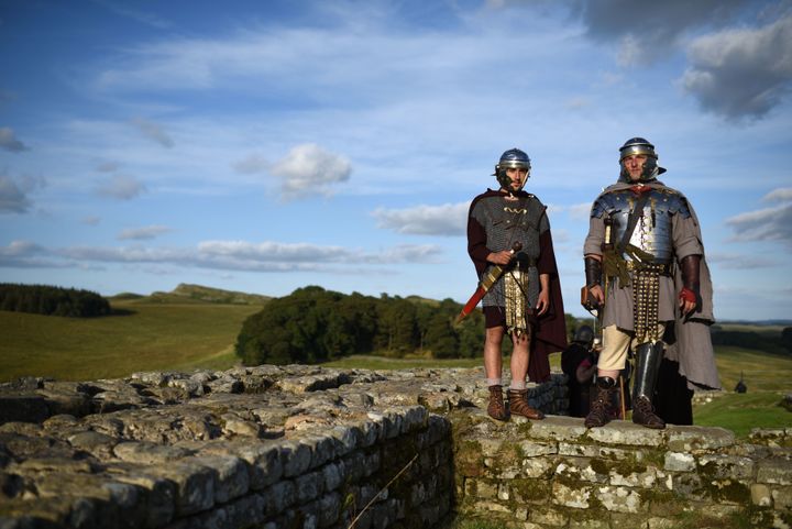Reenactors portraying soldiers from the Imperial Roman Army stand on Hadrian's Wall at Birdoswald Roman Fort near Gilsland, northern England on 5 September 2015. 