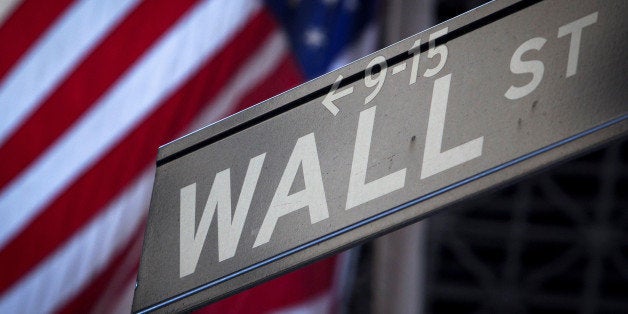 A Wall Street sign is pictured outside the New York Stock Exchange in New York, October 28, 2013. REUTERS/Carlo Allegri/File Photo