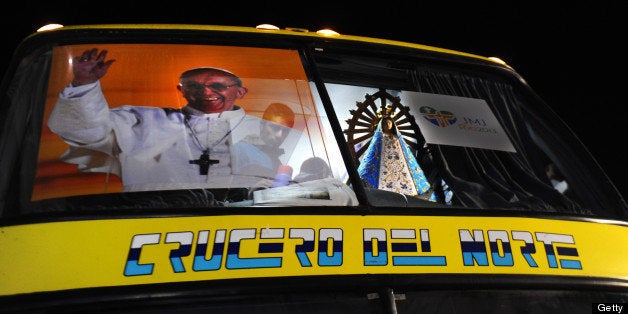 With a poster of Pope Francis and the Virgin of Lujan, the bus leading a convoy taking some 400 Argentine pilgrims to Rio de Janeiro for the week-long Catholic youth fest World Youth Day (WYD) to be headed by Pope Francis next week, departs from the Cathedral of Buenos Aires on July 19, 2013 after a mass. Some 1.5 million young pilgrims, including 350,000 from abroad, are expected to attend WYD. AFP PHOTO / DANIEL GARCIA (Photo credit should read DANIEL GARCIA/AFP/Getty Images)