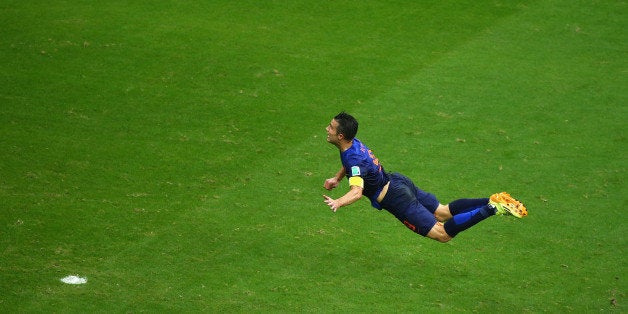 SALVADOR, BRAZIL - JUNE 13: Robin van Persie of the Netherlands scores the teams first goal with a diving header in the first