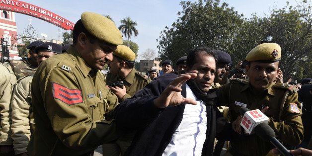 NEW DELHI, INDIA - FEBRUARY 5: Delhi Police detain an Indian Christian Father while protesting against recent attacks on churches in the Indian capital outside the Sacred Heart Church on February 5, 2015 in New Delhi, India. Police said the protesters were detained as they marched toward the residence of Home Minister Rajnath Singh in a high-security area where protests are banned. Earlier this week, a church was vandalized in New Delhi when unidentified people broke in and desecrated holy objects kept in the church, the fifth such attack on a Christian church since December. (Photo by Sonu Mehta/Hindustan Times via Getty Images)