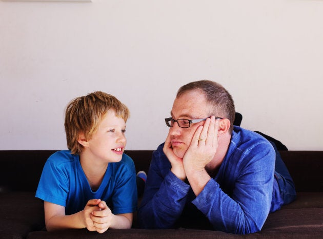father and son lying on the bed