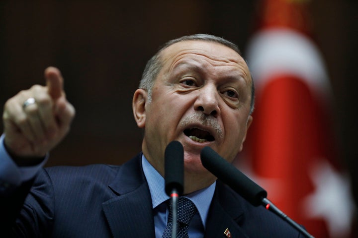 Turkey's President Recep Tayyip Erdogan gestures as he delivers a speech to MPs of his ruling Justice and Development Party (