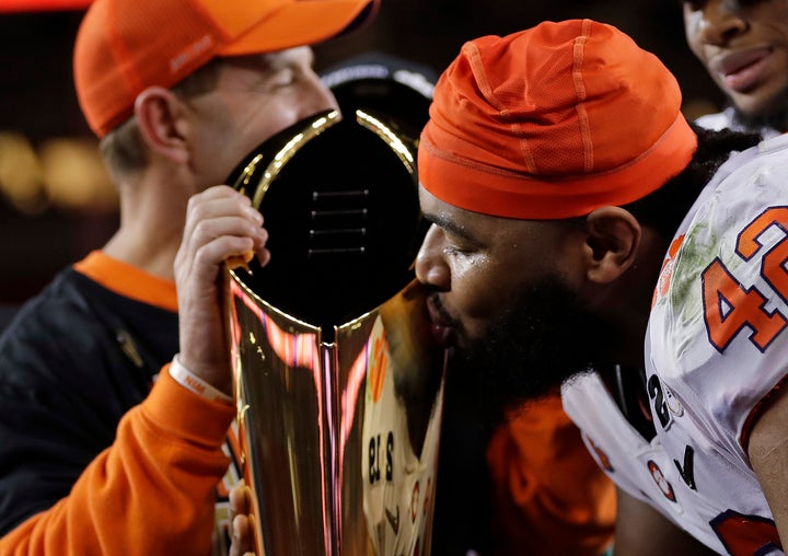 Clemson defensive lineman Christian Wilkins kisses the trophy after winning the championship Monday night.