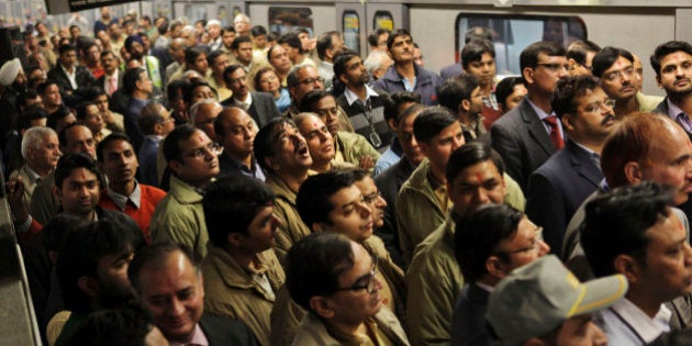 Indian metro workers listen to an announcement during the flag off for the trial run of the first section of the Phase III route between Central Secretariat and Mandi House stations, a distance of 3 kilometers (2 miles), in New Delhi, India, Monday, Dec. 30, 2013. The Phase III stretch of the metro line extends to 140 kilometers (87 miles), according to local reports. (AP Photo/Tsering Topgyal)