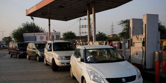 Vehicles are refueled at a petrol station in New Delhi, India, Thursday, Oct. 16, 2014. A sudden plunge in the price of oil is sending economic and political shockwaves around the world. Oil exporting countries are bracing for potentially crippling budget shortfalls and importing nations are benefiting from the lowest prices in four years. India imports three-quarters of its oil and analysts say falling oil prices will ease the country's chronic current account deficit. (AP Photo/Altaf Qadri)