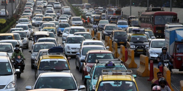 Traffic clogs a road in Mumbai, India, Friday, Dec. 5, 2014. India says it is taking bold steps against climate change with plans for a five-fold increase in renewable energy capacity. However, Environment Minister Prakash Javadekar said the country won't act to curb carbon emissions because it first must pursue economic growth to eradicate poverty. (AP Photo/Rajanish Kakade)