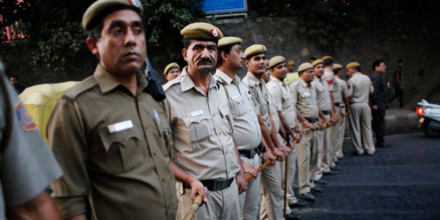 Indian policemen form a human barricade to prevent supporters of the 'Kiss of Loveâ campaign from marching towards the headquarters of the Hindu nationalist organization Rashtriya Swayamsevak Sangh's (RSS) in New Delhi, India, Saturday, Nov. 8, 2014. The campaign was launched to protest alleged increase in moral policing by Hindu right-wing organizations in India. (AP Photo/Altaf Qadri)