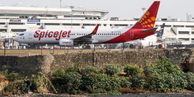 A SpiceJet Ltd. aircraft stands on the tarmac at Chhatrapati Shivaji International Airport in Mumbai, India, on Thursday, May 23, 2013. SpiceJet, India's third largest Indian airline by domestic market share, is scheduled to release their fourth-quarter earnings on May 24. Photographer: Dhiraj Singh/Bloomberg via Getty Images