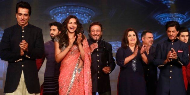From left to right, Bollywood actors Sonu Sood, Abhishek Bachchan, Deepika Padukone, Jackie Shroff, Director Farah Khan, Boman Irani, Shah Rukh Khan and Vivaan Shah applaud during a promotional event for their upcoming film