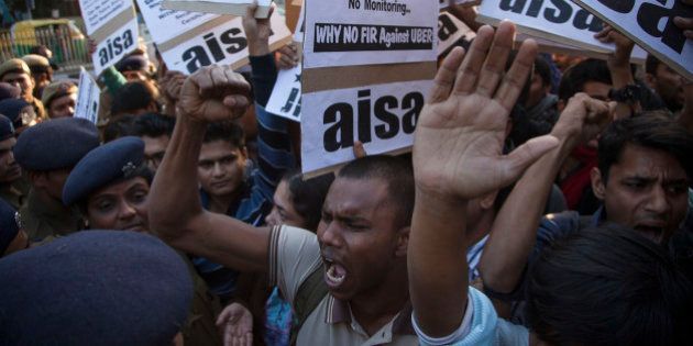 Protestors from All India Students Association (AISA) demonstrate outside the Delhi Police headquarters after a taxi driver from the international cab-booking service Uber allegedly raped a young woman Friday in New Delhi, India, Sunday, Dec. 7, 2014. Official statistics say about 25,000 rapes are committed every year in India, a nation of 1.2 billion people. (AP Photo/Tsering Topgyal)