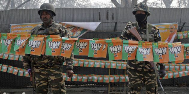 SRINAGAR, INDIA - DECEMBER 08: Indian paramilitary soldiers stand guard outside Sher-i-Kashmir cricket stadium where Indias Prime Minister Narendra Modi will address a campaign rally in Srinagar, Kashmir on December 8, 2014. Modi will address a campaign rally ahead of local elections in Indian-held Kashmir, to boost his Hindu nationalist Bharatiya Janata Party (BJP) to win a first-ever majority in the troubled Muslim-majority region. (Photo by Ahmer Khan/Anadolu Agency/Getty Images)