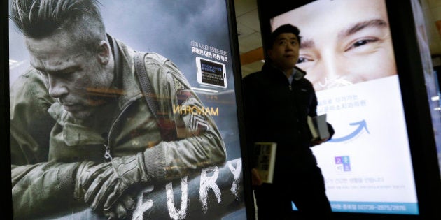 A man passes by a poster advertising Sony Pictures movie