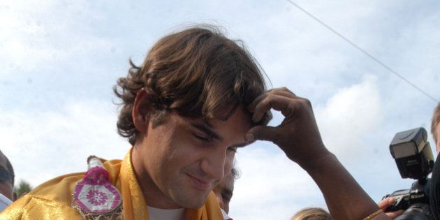 Tennis Player and UNICEF Goodwill Ambassador Roger Federer is welcomed in traditional way on his visit to Thazzhanguda village 165 kilometers (103 miles) south of Chennai, India, Friday, Dec 22, 2006. Federer visited various UNICEF projects for the rehabilitation of Tsunami victims. (AP Photo/ M.Lakshman)