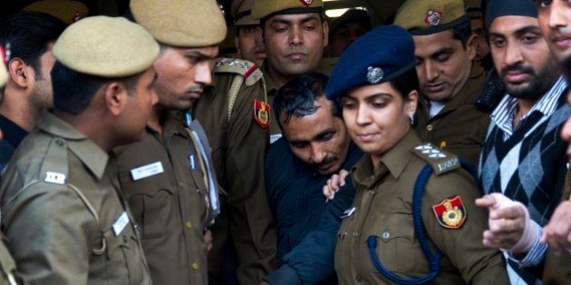 32-year-old Shiv Kumar Yadav, center, a driver from the international taxi-booking service Uber, is surrounded by police as he is brought out after being produced in a court in New Delhi, India, Monday, Dec. 8, 2014. The court ordered Yadav be held for three days for police questioning over allegations that he raped a finance company employee after being hired to ferry her home from a dinner engagement on Friday night. (AP Photo/Saurabh Das)