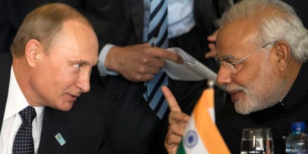 Russia's President Vladimir Putin, left, and India's Prime Minister Narendra Modi chat during the BRICS Summit at the Itamaraty Palace, in Brasilia, Brazil, Wednesday, July 16, 2014. (AP Photo/Felipe Dana)