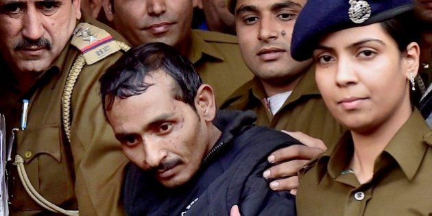 32-year-old Shiv Kumar Yadav, center, a driver from the international taxi-booking service Uber, is surrounded by police as he is brought out after being produced in a court in New Delhi, India, Monday, Dec. 8, 2014. The court ordered Yadav be held for three days for police questioning over allegations that he raped a finance company employee after being hired to ferry her home from a dinner engagement on Friday night. (AP Photo/Press Trust of India)INDIA OUT