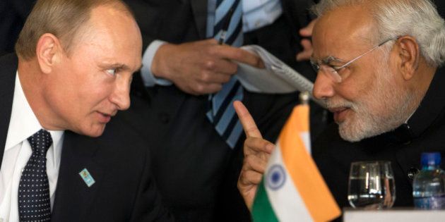 Russia's President Vladimir Putin, left, and India's Prime Minister Narendra Modi chat during the BRICS Summit at the Itamaraty Palace, in Brasilia, Brazil, Wednesday, July 16, 2014. (AP Photo/Felipe Dana)