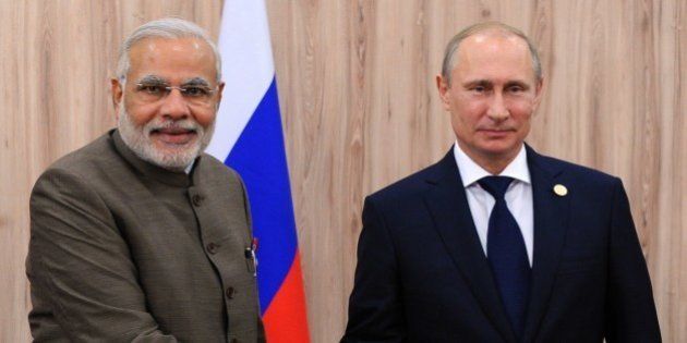India's Prime Minister Narendra Modi (L) shakes hands with Russia's President Vladimir Putin during their meeting on the sidelines of the BRICS group leaders sumit in Fortaleza, Brazil, on July 16, 2014. Leaders of the BRICS group of emerging powers ( Brazil, Russia, India, China and South Africa) met today to launch a new development bank and a reserve fund seen as counterweights to Western-led financial institutions. AFP PHOTO / RIA-NOVOSTI / POOL / MIKHAIL KLIMENTYEV (Photo credit should read MIKHAIL KLIMENTYEV/AFP/Getty Images)