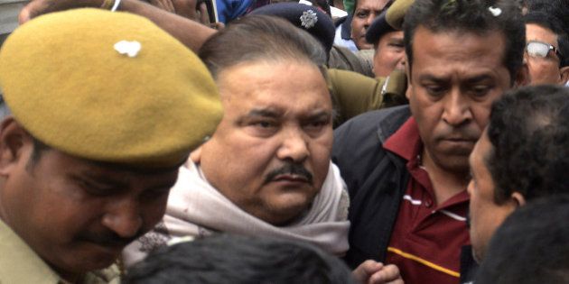 KOLKATA, INDIA - DECEMBER 13: Madan Mitra, West Bengal Transport Minister (Trinamool Congress) being taken to the Alipore court from the CBI office, at Saltlake on December 13, 2014 in Kolkata, India. He has been arrested in connection with the multi-crore Saradha chit fund scam. Thousands of investors allegedly lost over INR 200-300 billion when Saradha chit fund group collapsed in April 2013. (Photo By Subhendu Ghosh/Hindustan Times via Getty Images)