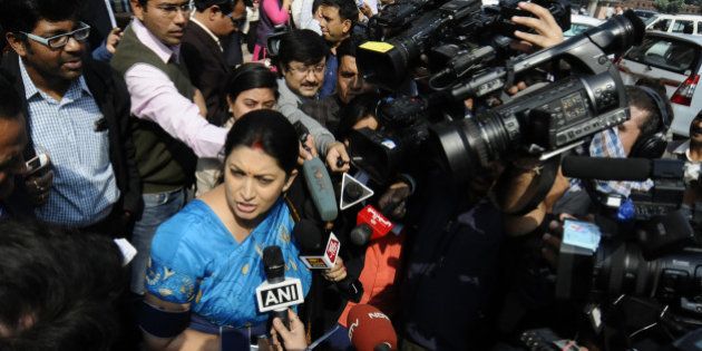 NEW DELHI, INDIA- NOVEMBER 24: Smriti Irani, Union Minister of HRD talking to media personnel during the opening day of the winter session of Parliament on November 24, 2014 in New Delhi, India. The Narendra Modi government, which has promised big reforms in its first budget, is looking to push the Insurance Bill as well as the Goods and Service Tax Bill in the month-long winter session that begins today. (Photo by Vipin Kumar/ Hindustan Times via Getty Images)