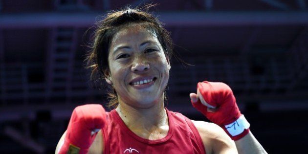 Gold medallist India's Hmangte Chungneijang Mary Kom reacts after being declared the winner of the women's flyweight (48-51kg) boxing final match against Kazakhstan's Shekerbekova Zhaina during the 2014 Asian Games at the Seonhak Gymnasium in Incheon on October 1, 2014. AFP PHOTO/ INDRANIL MUKHERJEE (Photo credit should read INDRANIL MUKHERJEE/AFP/Getty Images)