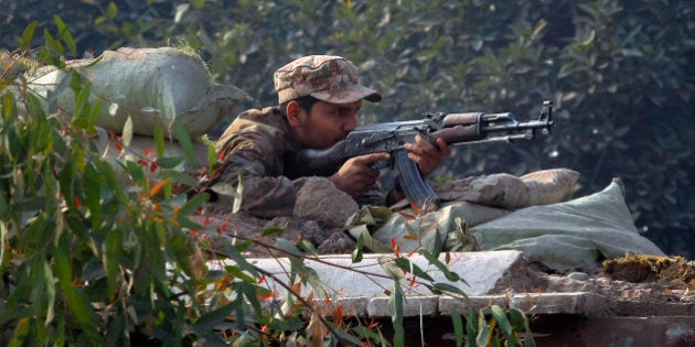 A Pakistani army soldier takes position on a bunker close to a school under attack by Taliban gunmen...