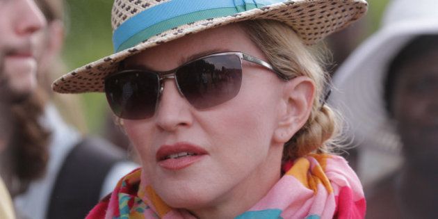 U.S singer Madonna arrives in Kasungu, about 150 kilometers north of the capital Lilongwe, Sunday, Nov. 30, 2014. Madonna is currently visiting Malawi with her son David and daughter Mercy, where she has been working since 2006 with her non profit organization, Raising Malawi. (AP Photo/Tsvangirayi Mukwazhi)