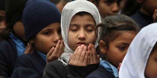 Pakistani students pray during a special ceremony for the victims of Tuesday's school attack in Peshawar, at a school in Lahore, Pakistan, Wednesday, Dec. 17, 2014. Pakistan is mourning as the nation prepares for mass funerals for 141 people, most of them children, killed in a Taliban attack on a military-run school in the country's northwest. (AP Photo/K.M. Chaudary)