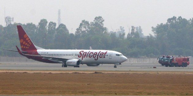 NEW DELHI, INDIA - MAY 24: Fire trucks surround a Spicejet Boeing 737-800 aircraft which made an emergency landing at Indira Gandhi International airport on May 24, 2010 in New Delhi, India. An Indian passenger jet carrying 184 people on board made an emergency landing in New Delhi's main airport on May 24, 2010 after the aircraft suffered a tyre-burst while taking off. The Boeing 737-800 aircraft aborted a flight to Srinagar city in Kashmir and returned to the Indira Gandhi Airport which declared a 'full emergency' before it was allowed to land, officials said. (Photo by Barcroft India / Getty Images)