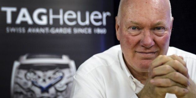 Swiss watchmaker Tag Heuer's new CEO Jean-Claude Biver gestures during a press conference at compagny headquarters on December 16, 2014 in La Chaux-de-Fonds, Western Switzerland. The Tag Heuer watch brand, owned by the French luxury group LVMH, wants to resolutely take the turn of the connected watch, believing that this technology should find its place the luxury, Biver said on December 16. AFP PHOTO / FABRICE COFFRINI (Photo credit should read FABRICE COFFRINI/AFP/Getty Images)