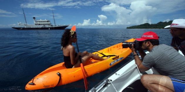 INDIA - NOVEMBER 04: Atul Kasbekar (Photographer) taking photograph of female model for Kingfisher calender in Port Blair, India. (Photo by Amit Kumar/The India Today Group/Getty Images)