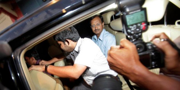 Satyam Computer Services Ltd. founder B. Ramalinga Raju, center, looks out from inside a car after he was released from Chanchalguda jail on being granted bail by the Supreme Court after he spent two years and eight months in the jail in Hyderabad, India, Saturday, Nov. 5, 2011. Raju, founder of the company that was once India's fourth largest software services company, confessed in January 2009 to inflating company assets by US$1.5 billion, a number government investigators later said was understated by at least US$1 billion. (AP Photo/Mahesh Kumar A)