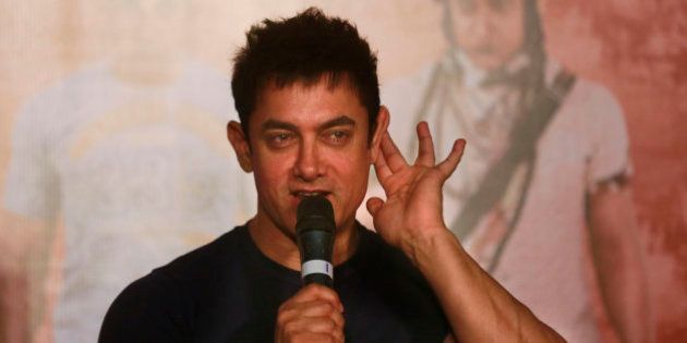 Bollywood actor Aamir Khan gestures as he speaks to the media during the teaser launch of his upcoming film