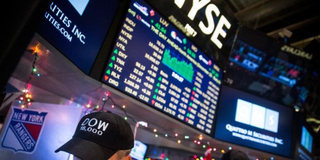 NEW YORK, NY - DECEMBER 23: Traders wear hats that say 'DOW 18,000' as they work on the floor of the New York Stock Exchange during the afternoon of December 23, 2014 in New York City. The Dow Jones Industrial Average crossed a landmark by closing above 18,000 points today. (Photo by Andrew Burton/Getty Images)