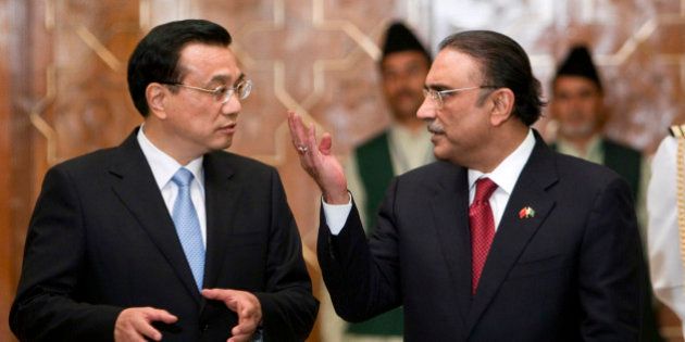 Visiting Chinese Premier Li Keqiang, left, speaks with Pakistani President Asif Ali Zardari, right, at a ceremony in Islamabad, Pakistan on Wednesday, May 22, 2013. China's premier began a two-day visit to Pakistan by praising the relationship between the two Asian powers in glowing terms. (AP Photo/Anjum Naveed)