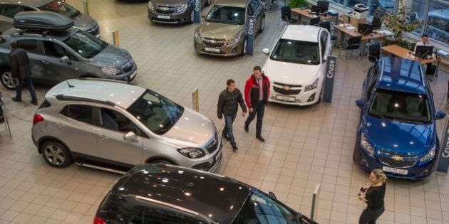 Customers examine cars on a display at an automobile dealership in Moscow, Russia, Saturday, Dec. 20, 2014.Shops selling a broad range of items were reporting record sales â some have even suspended operations, unsure of how far the ruble will sink. Apple, for one, has halted all online sales in Russia.(AP Photo/Denis Tyrin)