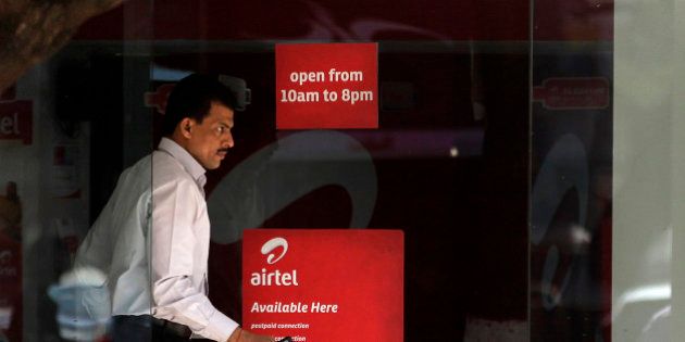 A man comes out from an Airtel center in Mumbai, India, Wednesday, Feb. 8, 2012. India's top mobile operator Bharti Airtel is reporting a 22 percent drop in quarterly profit due to higher interest rates and 3G network rollout costs, its eighth straight quarter of decline in net profit. (AP Photo/Rajanish Kakade)