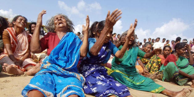 NAGAPATTINAM, INDIA: Indian survivors of the December 2004 tsunami burst into tears after they performed...