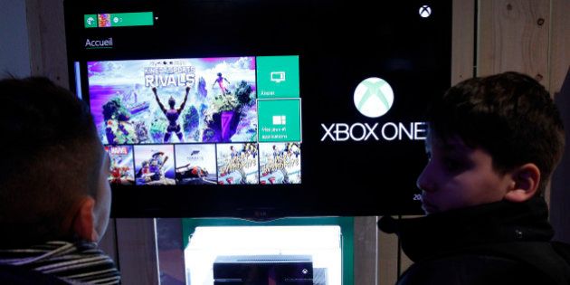 PARIS, FRANCE - DECEMBER 23: Visitors play a video game on Xbox One, produced by Microsoft during the 'Noel de Geek' at the Cite des Sciences et de l'ndustrie on December 23, 2014 in Paris, France. 'Noel de Geek' takes place from December 23, 2014 till January 04, 2015. (Photo by Chesnot/Getty Images)