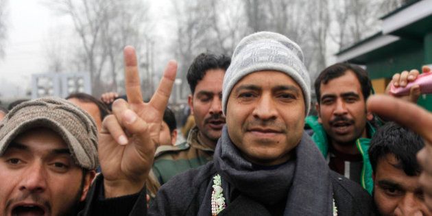 SRINAGAR, INDIA - DECEMBER 23: Peoples Democratic Party candidate from Sonawar constituency Mohammad Ashraf Mir gestures after winning against J & K incumbent Chief Minister Omar Abdullah outside a counting center on December 23, 2014 in Srinagar, India. Jammu and Kashmir was heading for a hung Assembly with PDP emerging as the single largest party by bagging 14 seats and leading in 16 while BJP also made gains by winning 18 seats and was ahead on 7, all in Jammu, but it failed to make inroads in the Valley. (Photo by Waseem Andrabi/Hindustan Times via Getty Images)