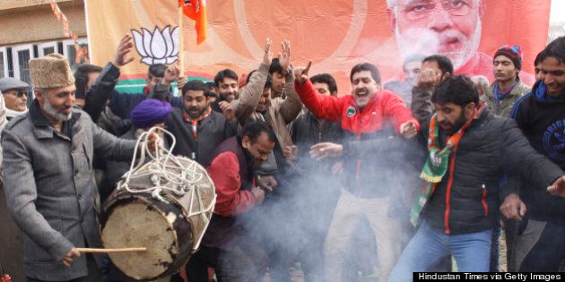 SRINAGAR, INDIA - DECEMBER 24: Bharatiya Janata Party supporters dance to celebrate their victory in the Jammu and Kashmir Assembly elections at party Headquarters on December 24, 2014 in Srinagar, India. Rightwing Hindu nationalist party led by Narendra Modi performed very well in only Muslim majority state of India as is emerged second largest party after PDP winning 25 out of total 87 seats. (Photo by Waseem Andrabi/Hindustan Times via Getty Images)
