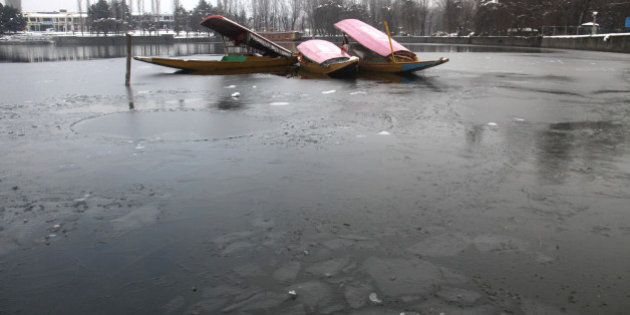 SRINAGAR, INDIA - JANUARY 2: The picture shows a frozen part of a Dal Lake on January 2, 2014 in Srinagar, India. A cold wave further tightened its grip in Jammu and Kashmir with most places recording sub-zero temperatures. (Photo by Waseem Andrabi/Hindustan Times via Getty Images)