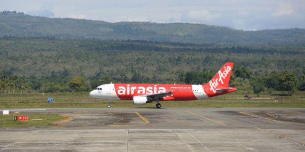 An AirAsia Bhd aircraft taxis on the runway at Sultan Iskandar Muda International Airport in Banda Aceh, Indonesia, on Thursday, Dec. 11, 2014. The tsunami unleashed a decade ago by a 9.1-magnitude undersea earthquake off the Sumatran coast was the deadliest natural disaster this century, taking more than 220,000 lives and leaving more than 1.5 million homeless. While families will never be rebuilt nor the trauma forgotten, interviews with survivors across the devastated coastlines of Thailand, India, Sri Lanka and Indonesia show how lives have been transformed. Photographer: Dimas Ardian/Bloomberg via Getty Images