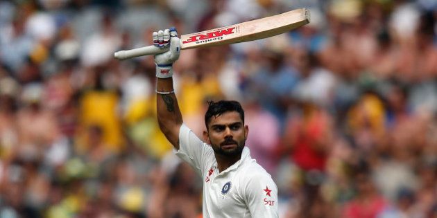 MELBOURNE, AUSTRALIA - DECEMBER 28: Virat Kohli of India raises his bat after scoring 100 runs during day three of the Third Test match between Australia and India at Melbourne Cricket Ground on December 28, 2014 in Melbourne, Australia. (Photo by Darrian Traynor/Getty Images)