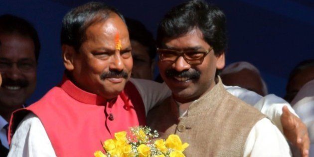 Newly elected Chief Minister of the eastern Indian state of Jharkhand Raghubar Das (L) is congratulated by former Chief Minister Hemant Soren after swearing an oath of office at a ceremony in Ranchi on December 28, 2014. Das of the Bharatiya Janata Party (BJP) was elected Chief Minister after the BJP won a convincing victory in recent state assembly elections which concluded on December 20. AFP PHOTO/STR (Photo credit should read STRDEL/AFP/Getty Images)